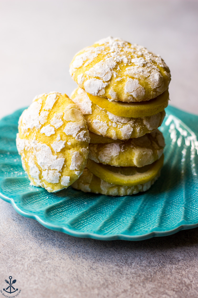 A stack of lemon cookies on a turquoise shell plate