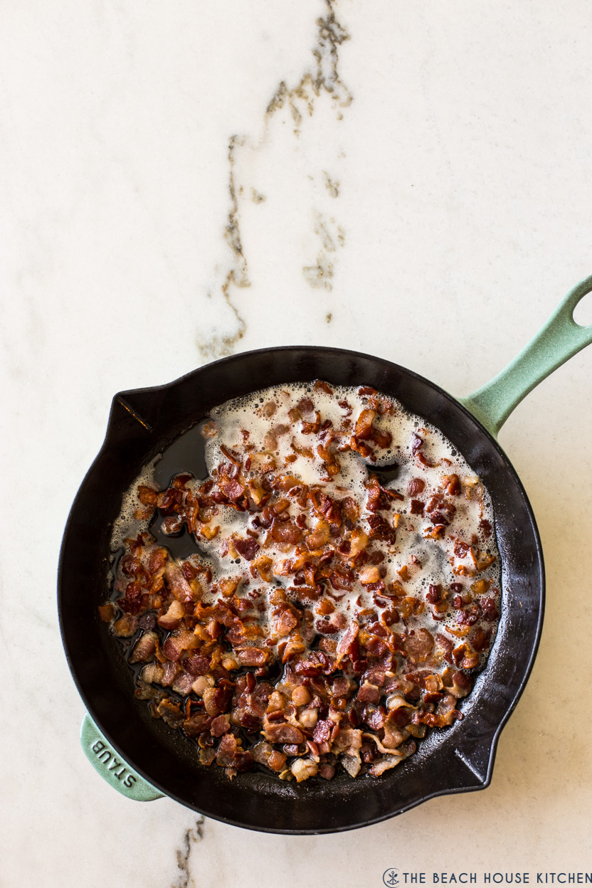 Overhead photo of a skillet of cooked diced bacon