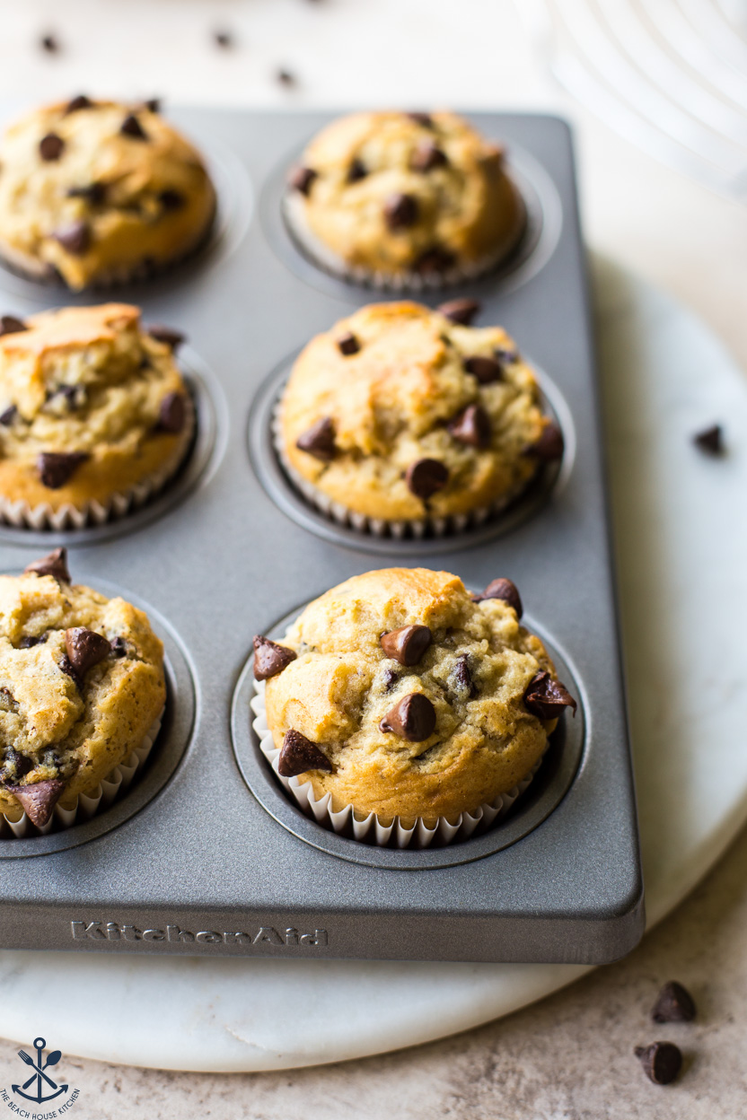 Up close photo of a muffin pan of chocolate chip muffins