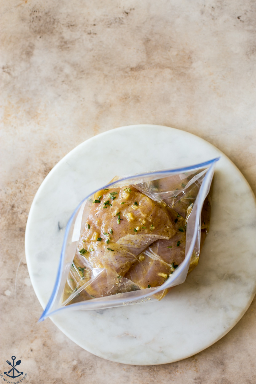 Overhead photo of a ziploc bag filled with turkey tenderloins and marinade