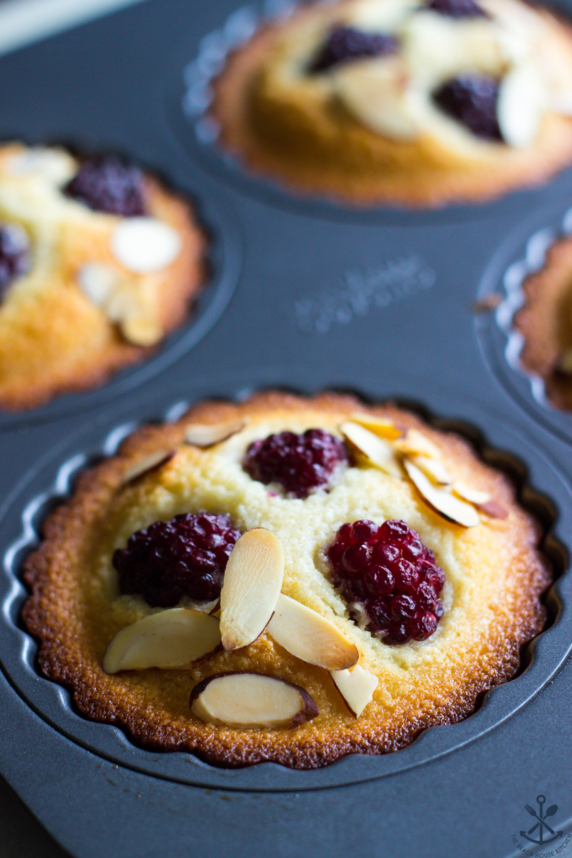 Up close photo of a french pastry topped with sliced almonds and blackberries
