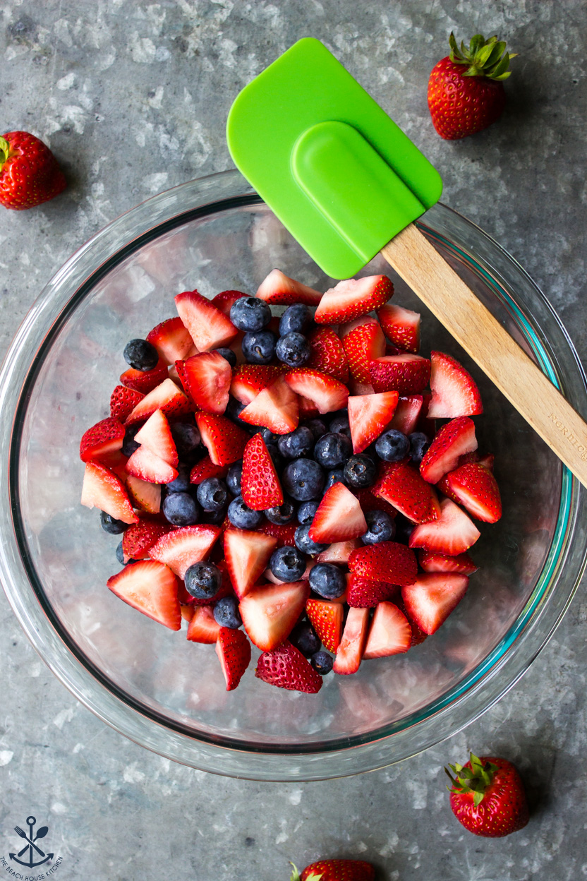 Overhead photo of a bowl of chopped strawberries and blueberries