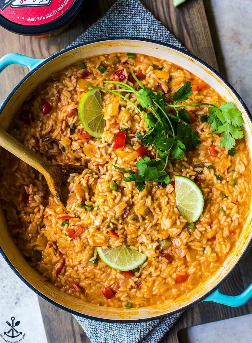 Up close overhead photo of a skillet of cheesy queso fiesta rice
