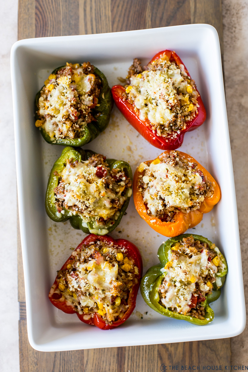 Overhead photo of stuffed peppers in a white baking dish