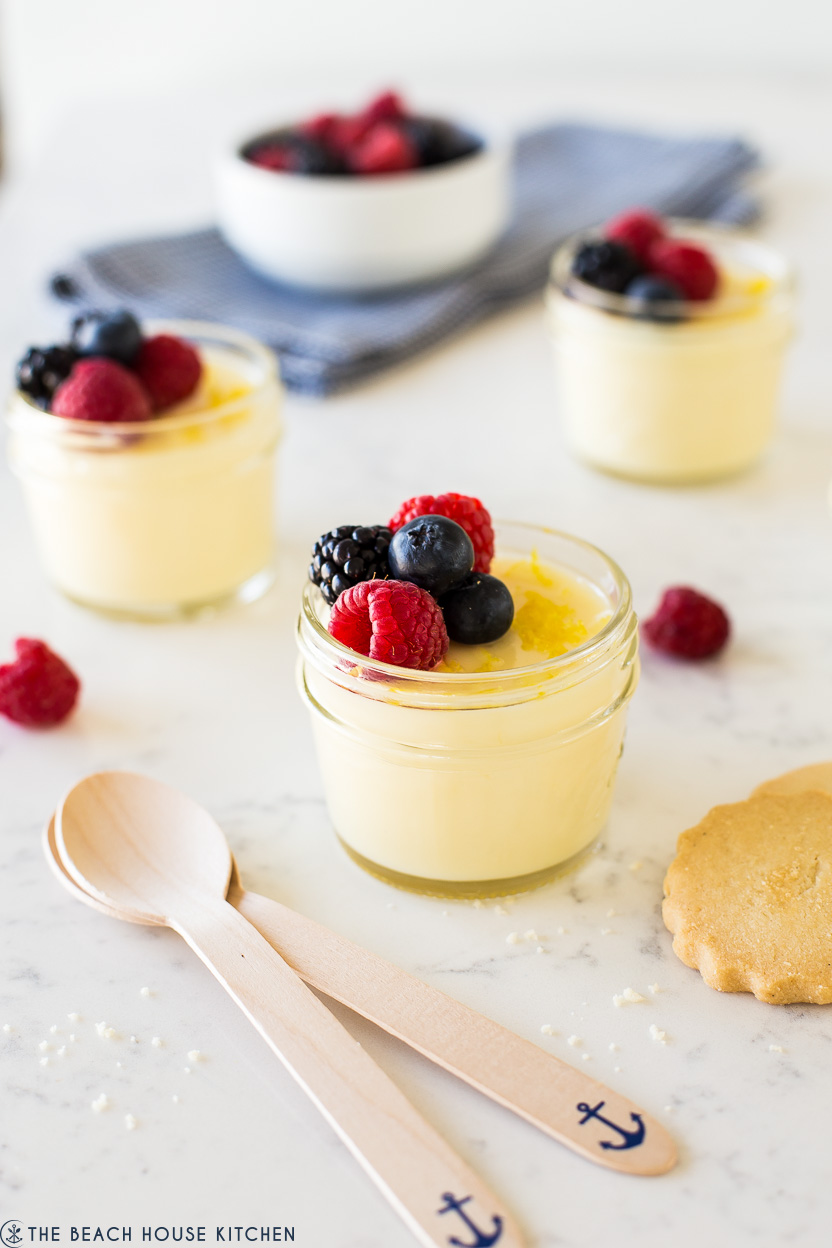 Up close photo of jar filled with lemon posset topped with berries