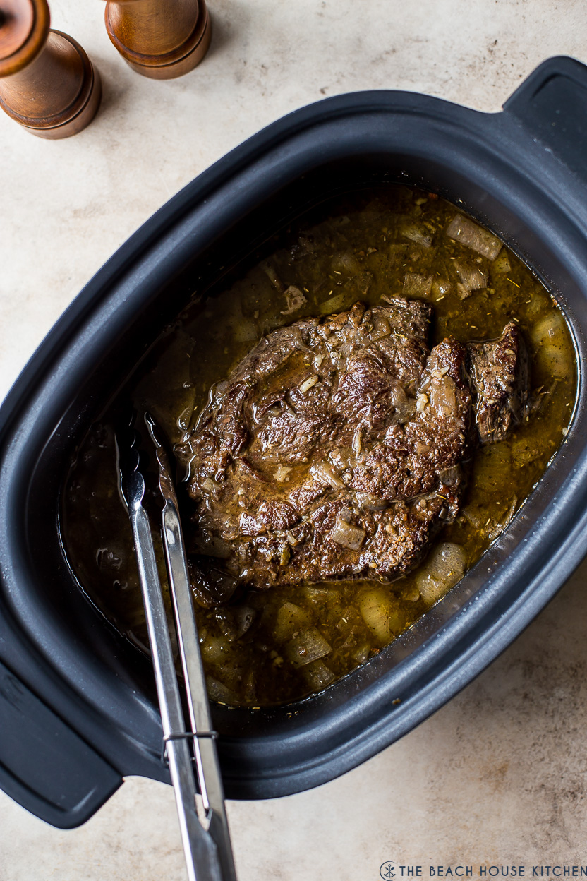 Overhead photo of cooked beef in a slow cooker