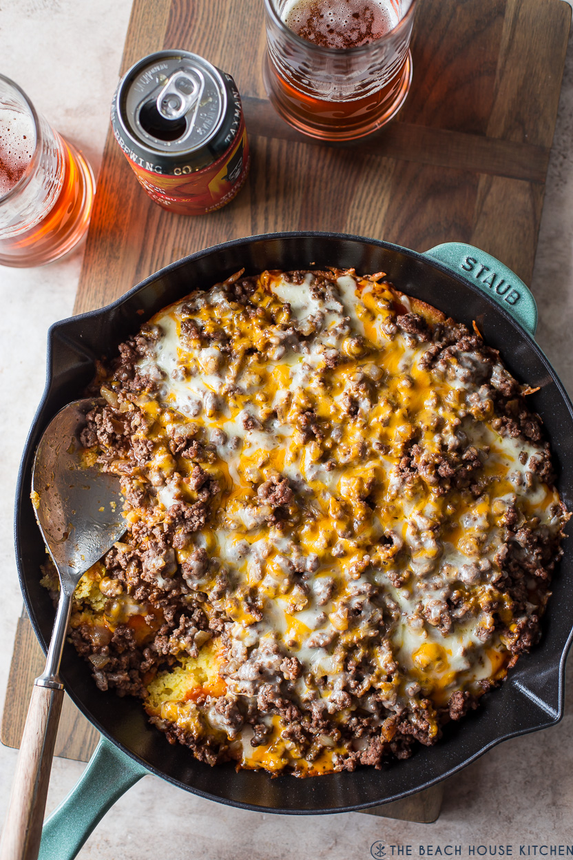 Overhead photo of a tamale pie in a skillet with a spoon