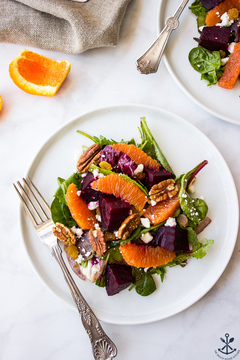 Overhead photo of a beet and orange salad on a white plate