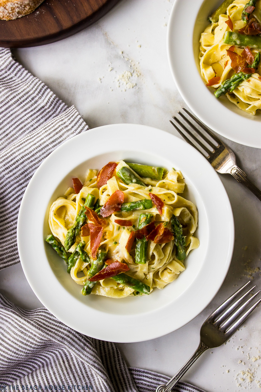 Up close overhead photo of a bowl of Fettuccine Alfredo with Asparagus and Crispy Prosciutto
