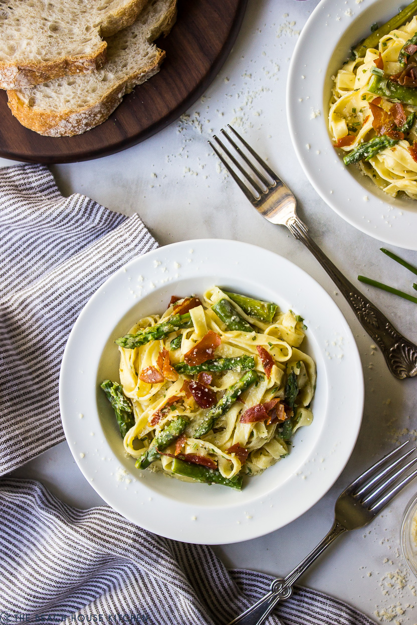 Overhead photo of a bowl of pasta with asparagus and prosciutto