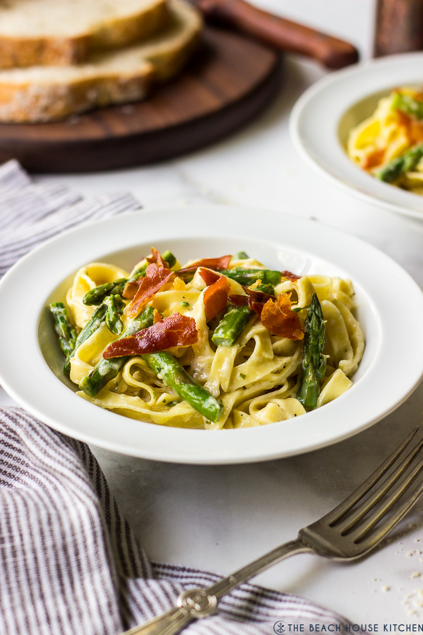 Photo of a bowl of pasta with asparagus and crispy prosciutto