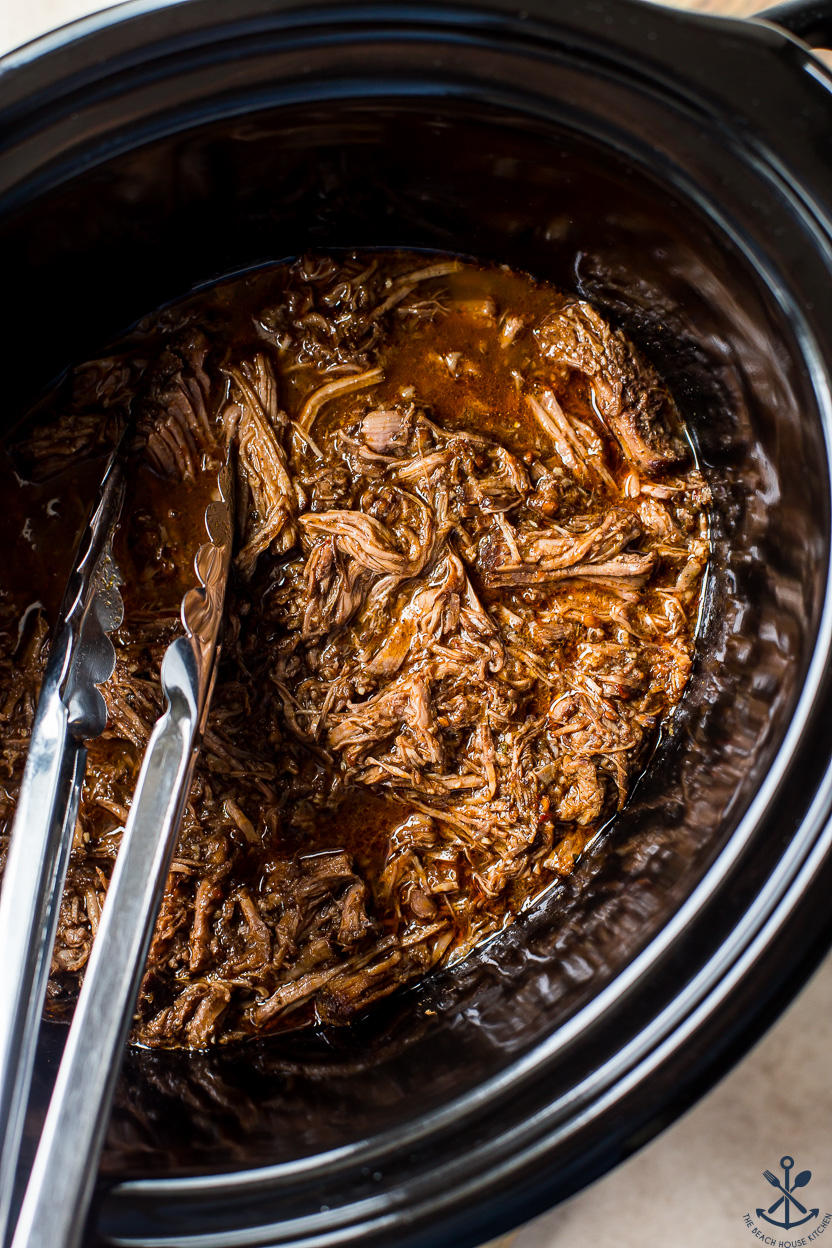 Up close overhead photo of a slow cooker beef barbacoa