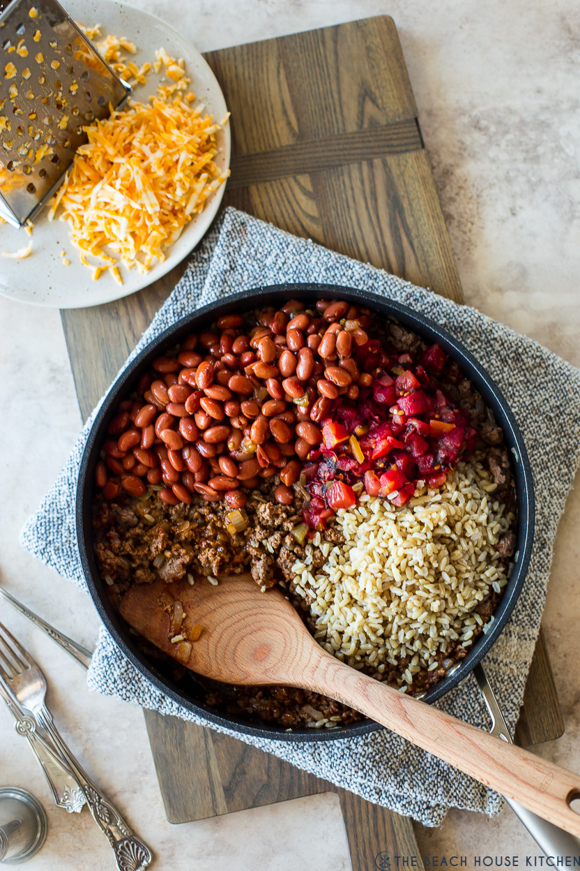 Overhead photo of a skillet filled with rice beans tomatoes and ground beef