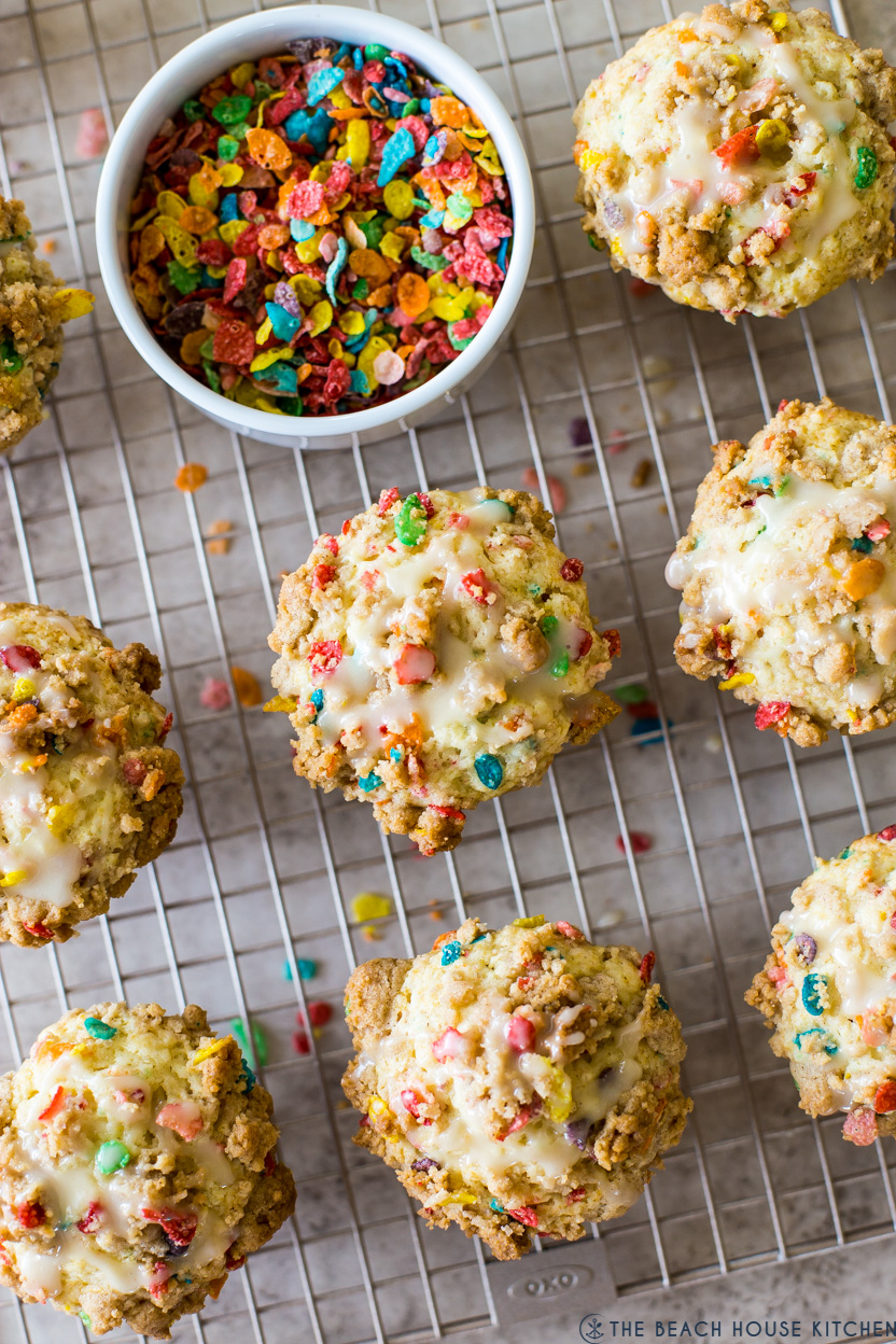 Overhead photo of Fruity Pebbles Streusel Muffins with a small bowl of Fruity Pebbles