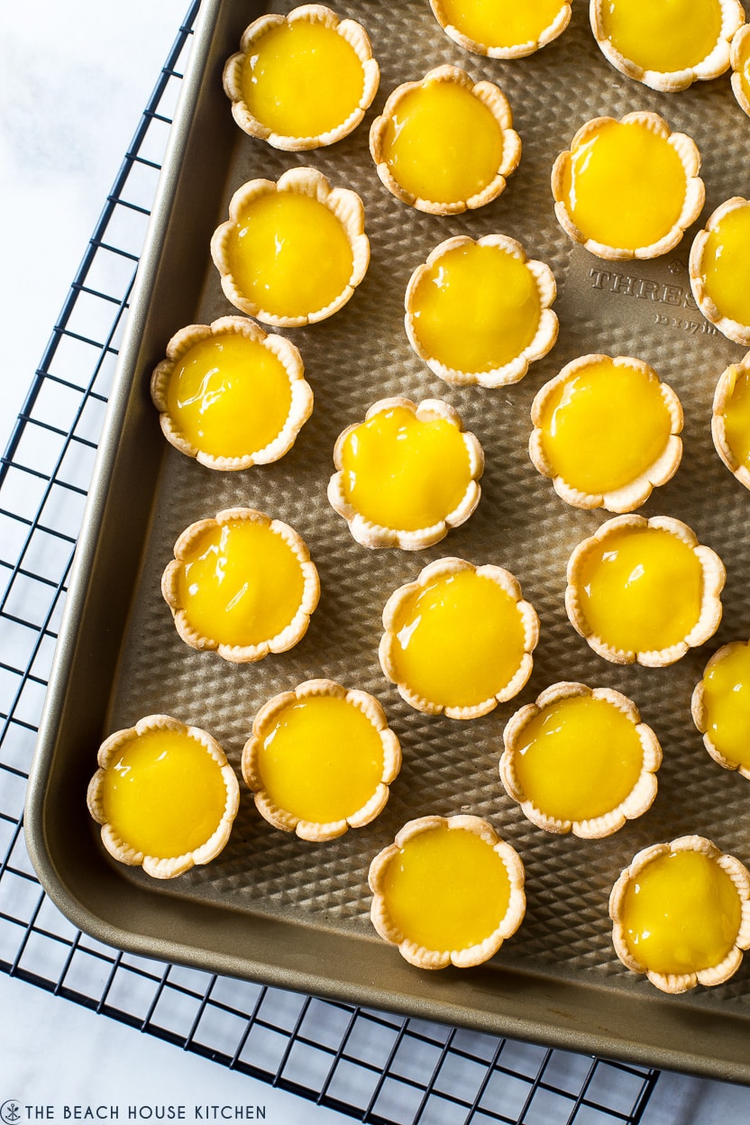 Overhead photo of mini pie shells filled with yellow lemon filling