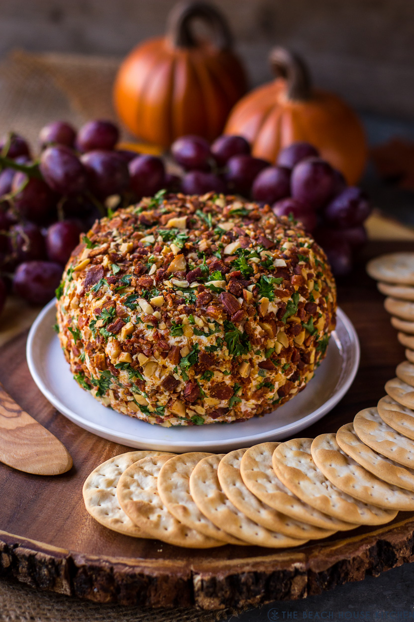 A Jalapeño Bacon Ranch Cheese Ball on a small plate with some crackers