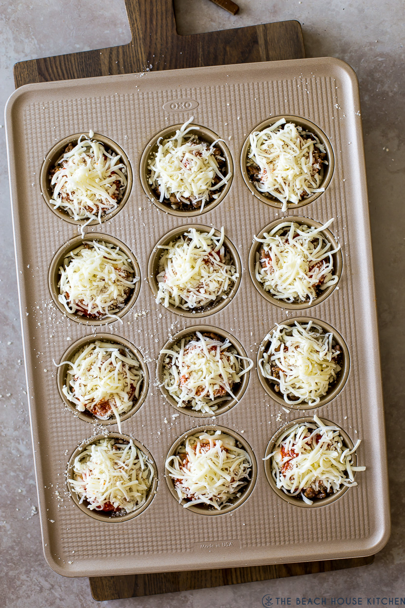 Overhead photo of pre-baked lasagna cups in a muffin tin