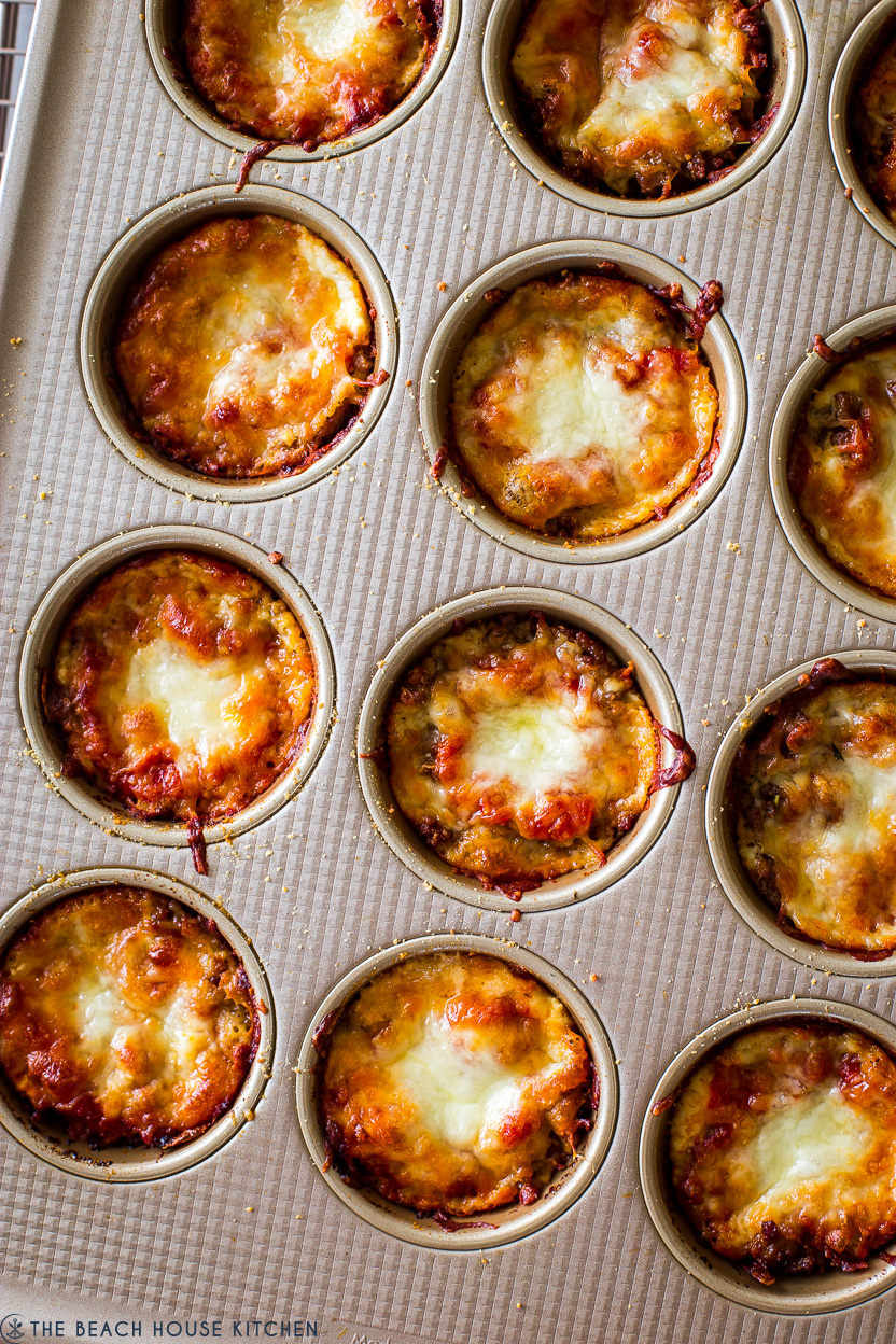 Up close overhead photo of lasagna cups in a muffin pan
