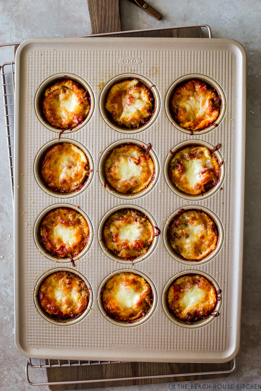 Overhead photo of a muffin pan filled with lasagna cups