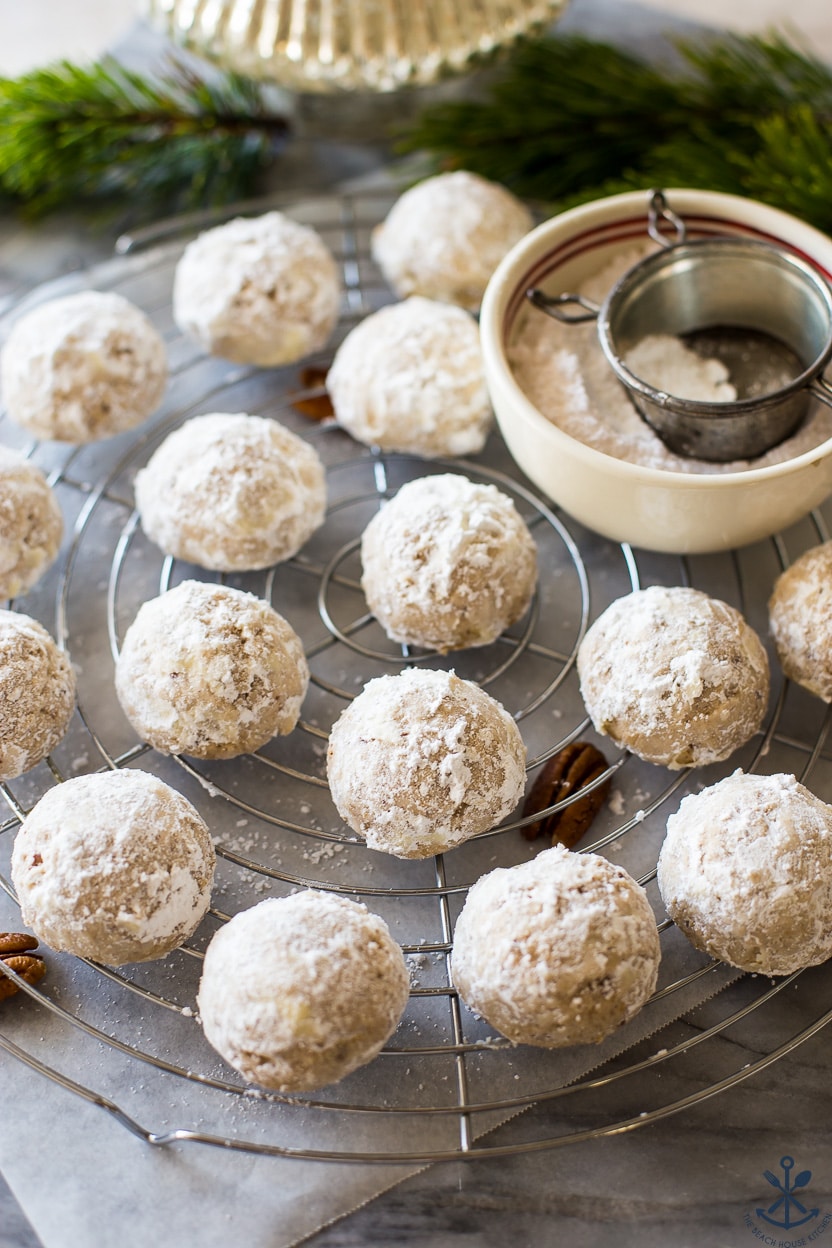 Maple Pecan Snowball Cookies on a round wire rack