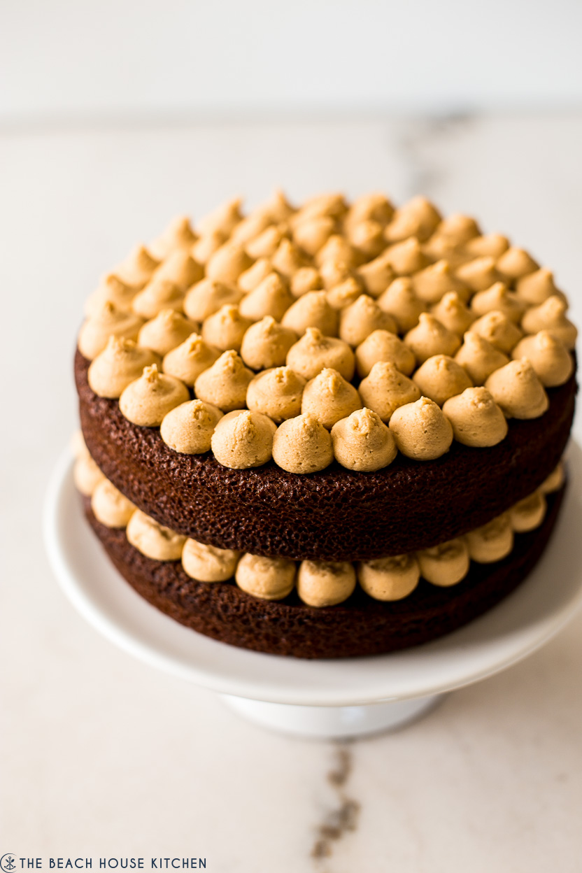 Up close photo of a chocolate cake with piped peanut butter frosting