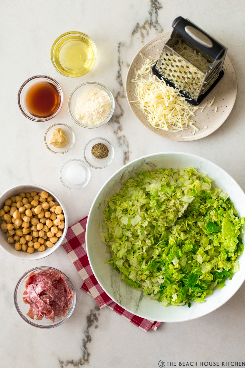 Overhead photo of ingredients for a chopped salad with chick peas and salami
