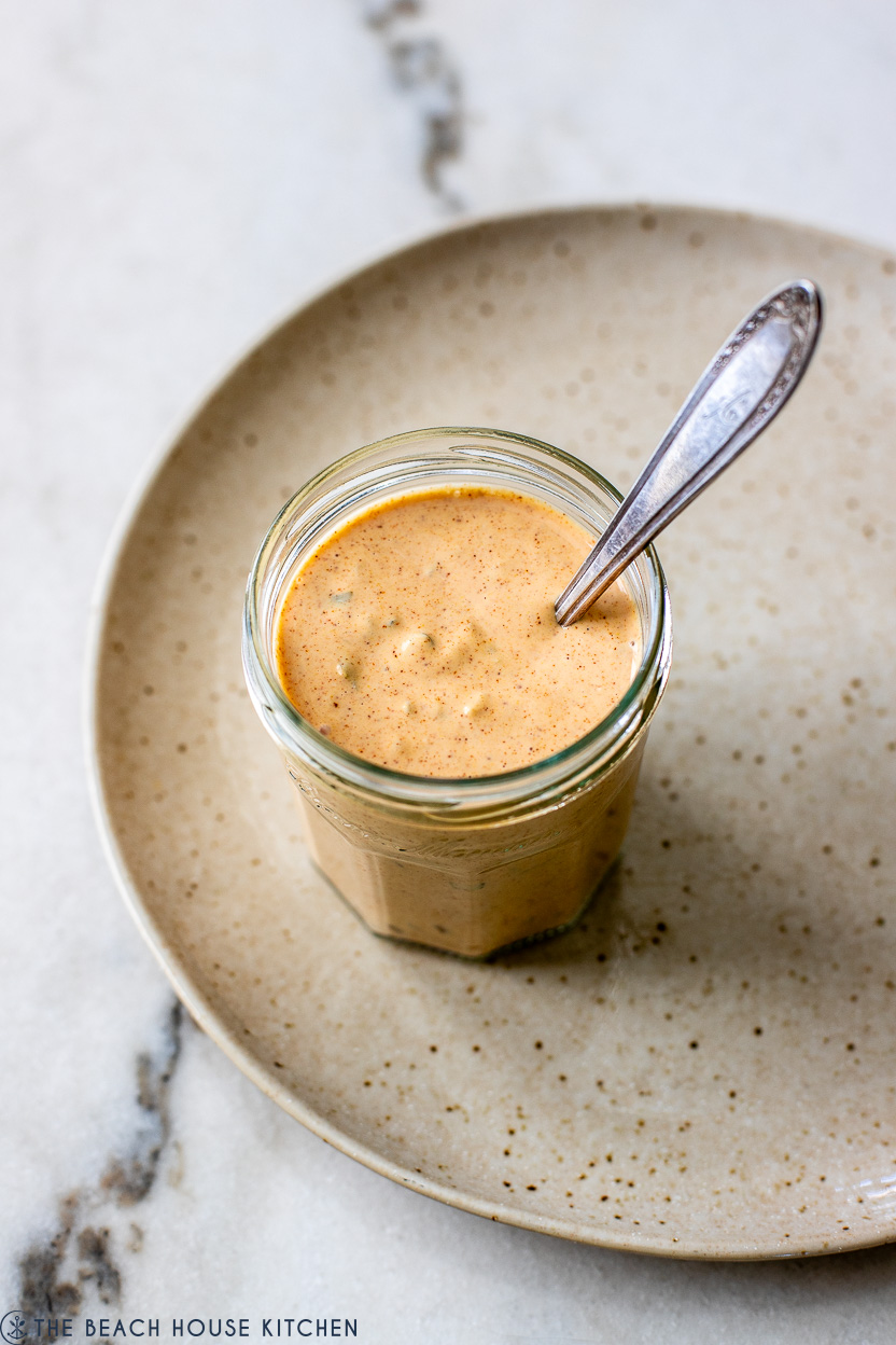 A jar of burger sauce in a jar on a plate