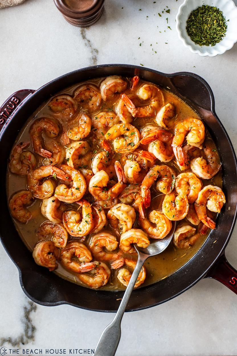 Overhead photo of a skillet of New Orleans-Style BBQ Shrimp