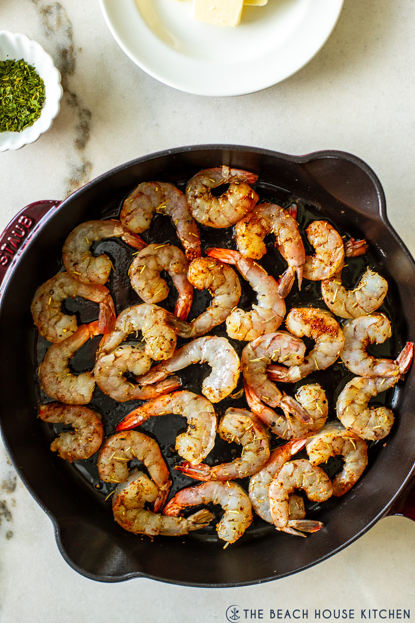 Up close overhead photo of a skillet of cooked shrimp