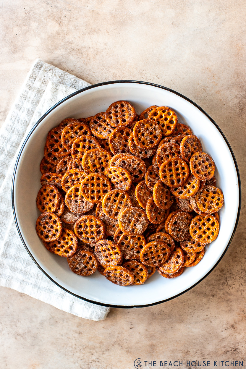 Overhead photo of a white enamel bowl of cinnamon sugar pretzel snaps