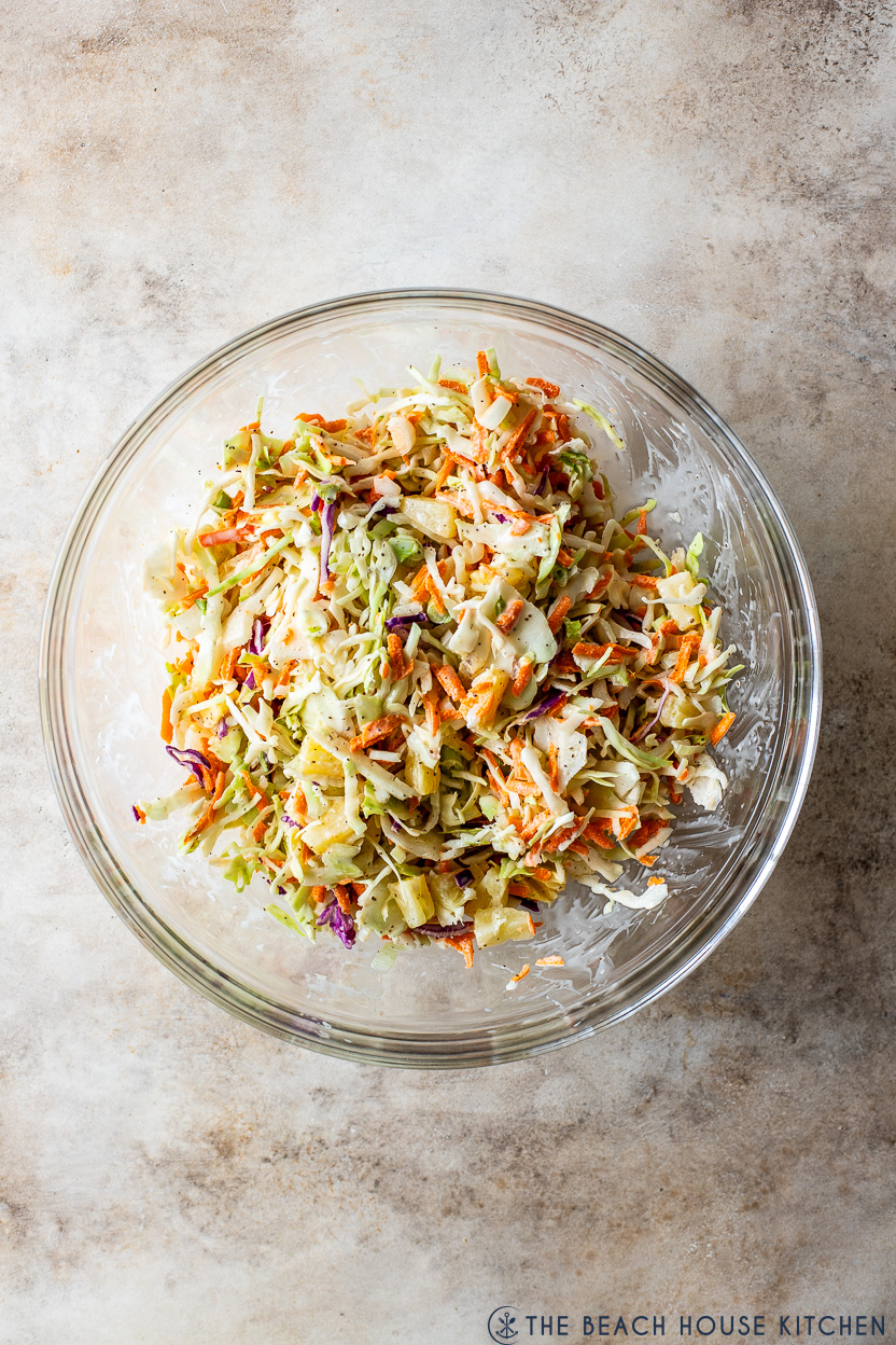 Overhead photo of a glass bowl of pineapple coleslaw