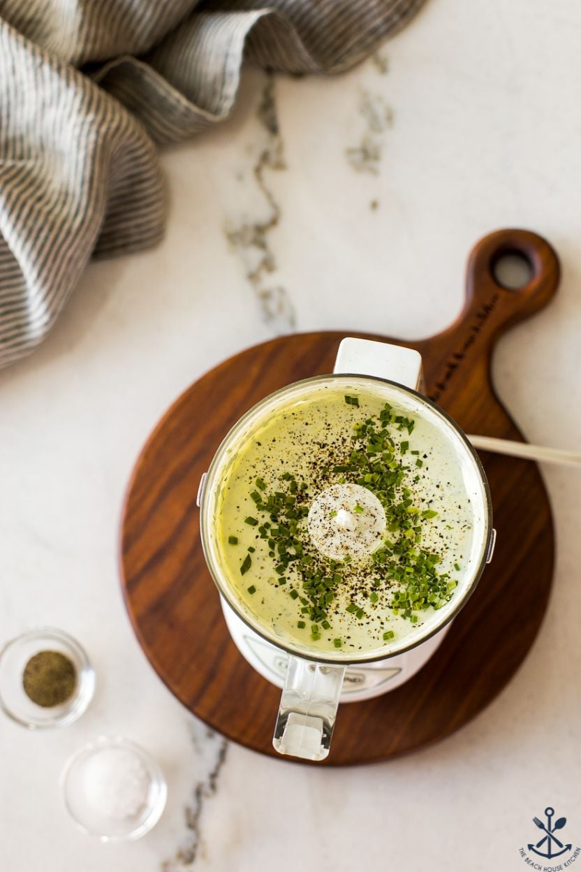 Overhead photo of a small food processor filled with a green goddess dressing