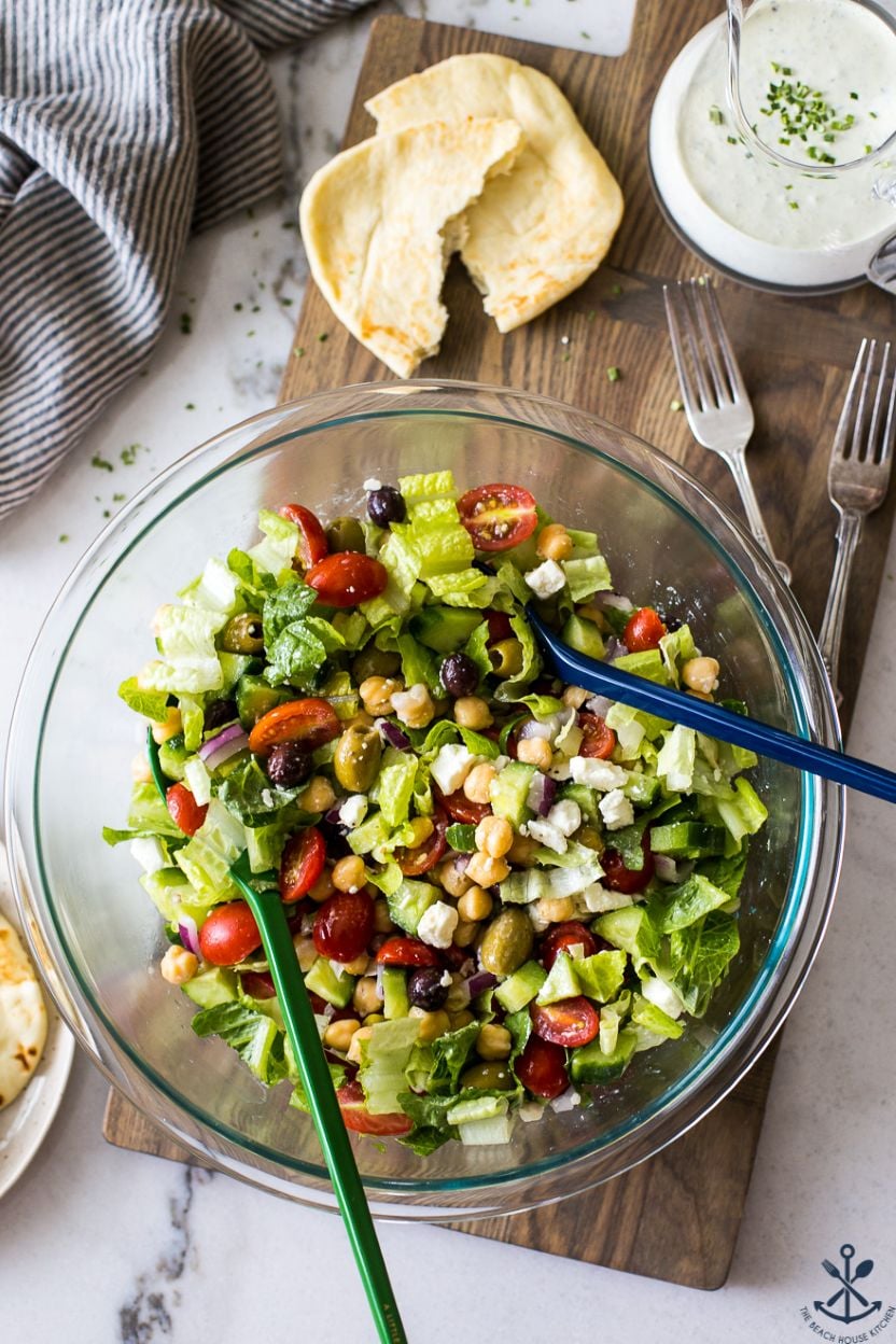 Overhead photo of a glass bowl filled with a Greek salad