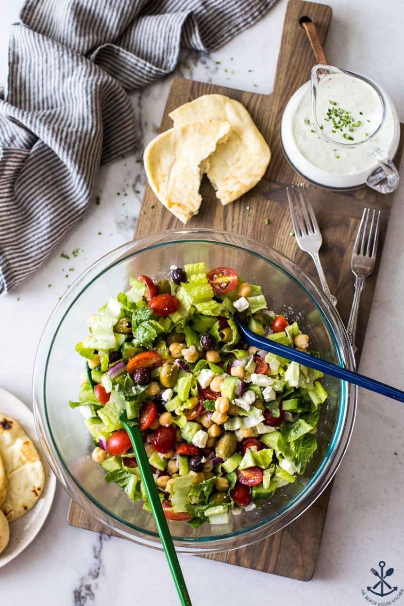 Overhead photo of a Greek Chickpea Salad with Green Goddess Dressing in a glass bowl