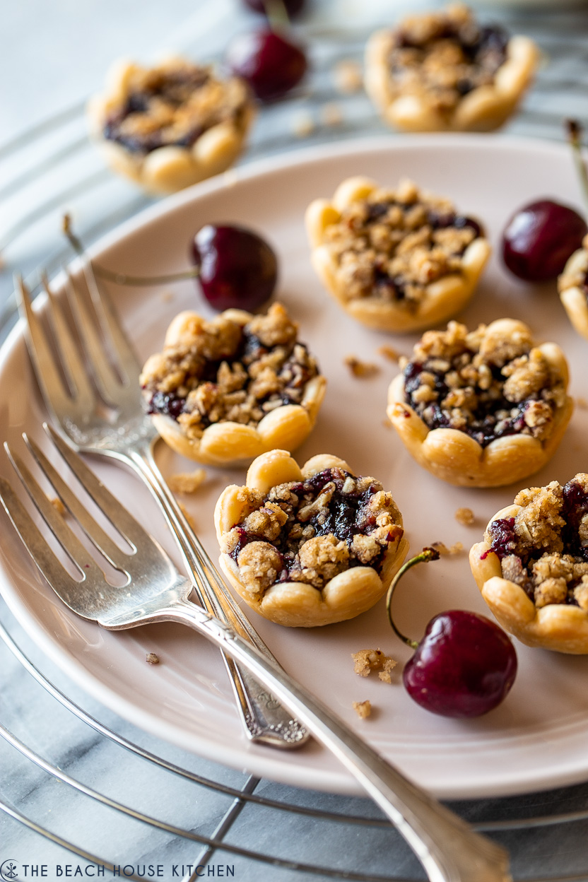 Up close photo of a plate of cherry pie bites with streusel on top