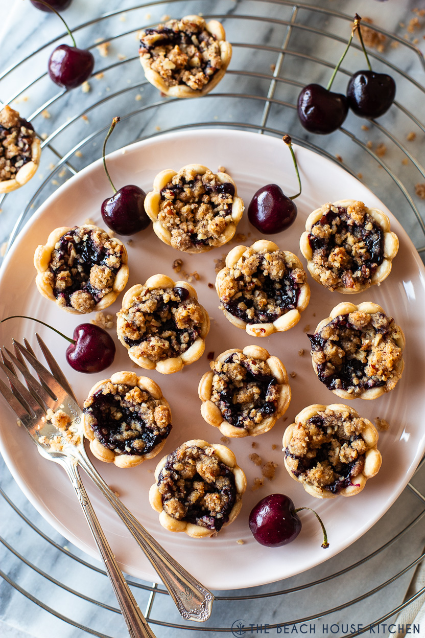 Up close overhead photo of a plate of streusel topped cherry pie bites