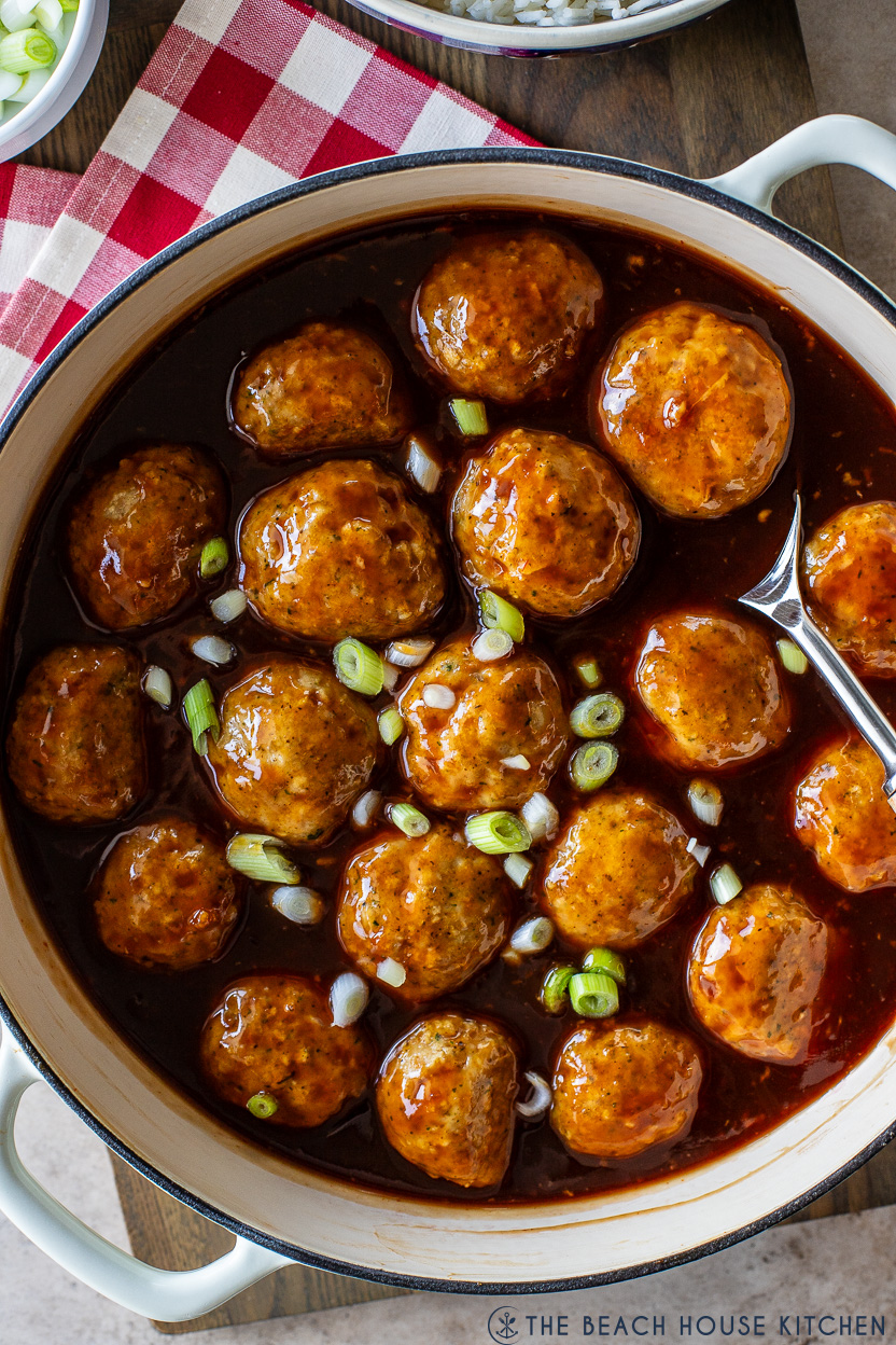 Up closeoverhead photo of a skillet of huli huli chicken meatballs