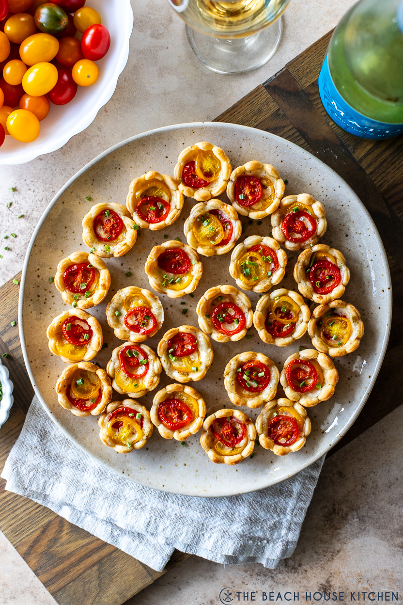 Overhead photo of a plate of mini heirloom tomatoes pies