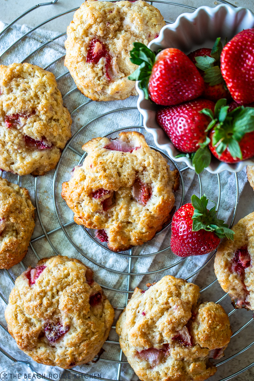 Up close overhead photo of strawberry drop biscuits on a round wire rack