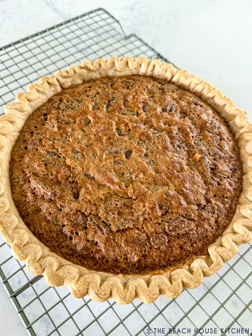 An easy Chocolate Chip Pie pie on a wire rack