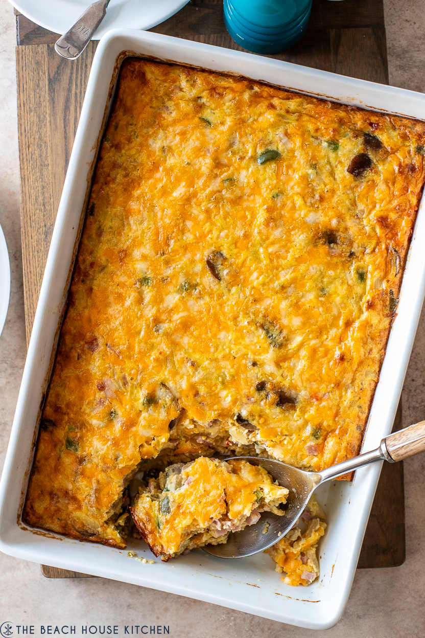 Overhead photo of a white baking dish filled with a Ham and Vegetable Hash Brown Breakfast Casserole