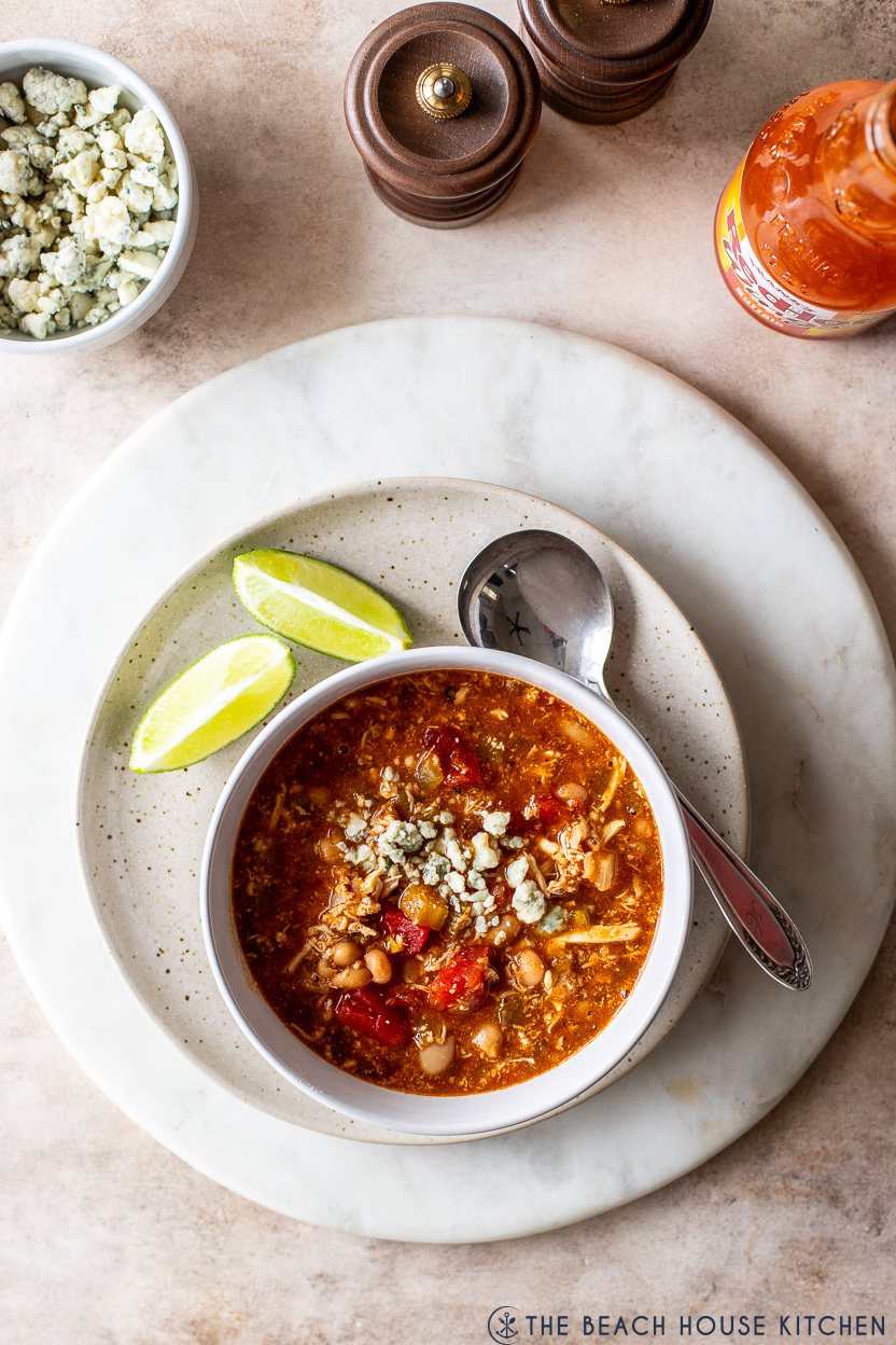 Overhead photo of a bowl of buffalo chicken chili topped with blue cheese crumbles