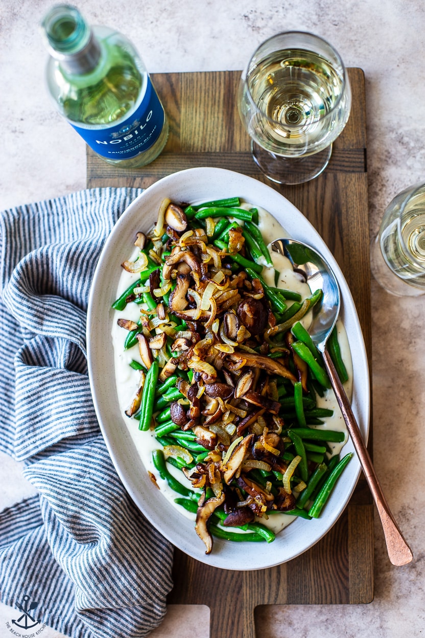 Overhead photo of an oval plate topped with green beans mushrooms and onions