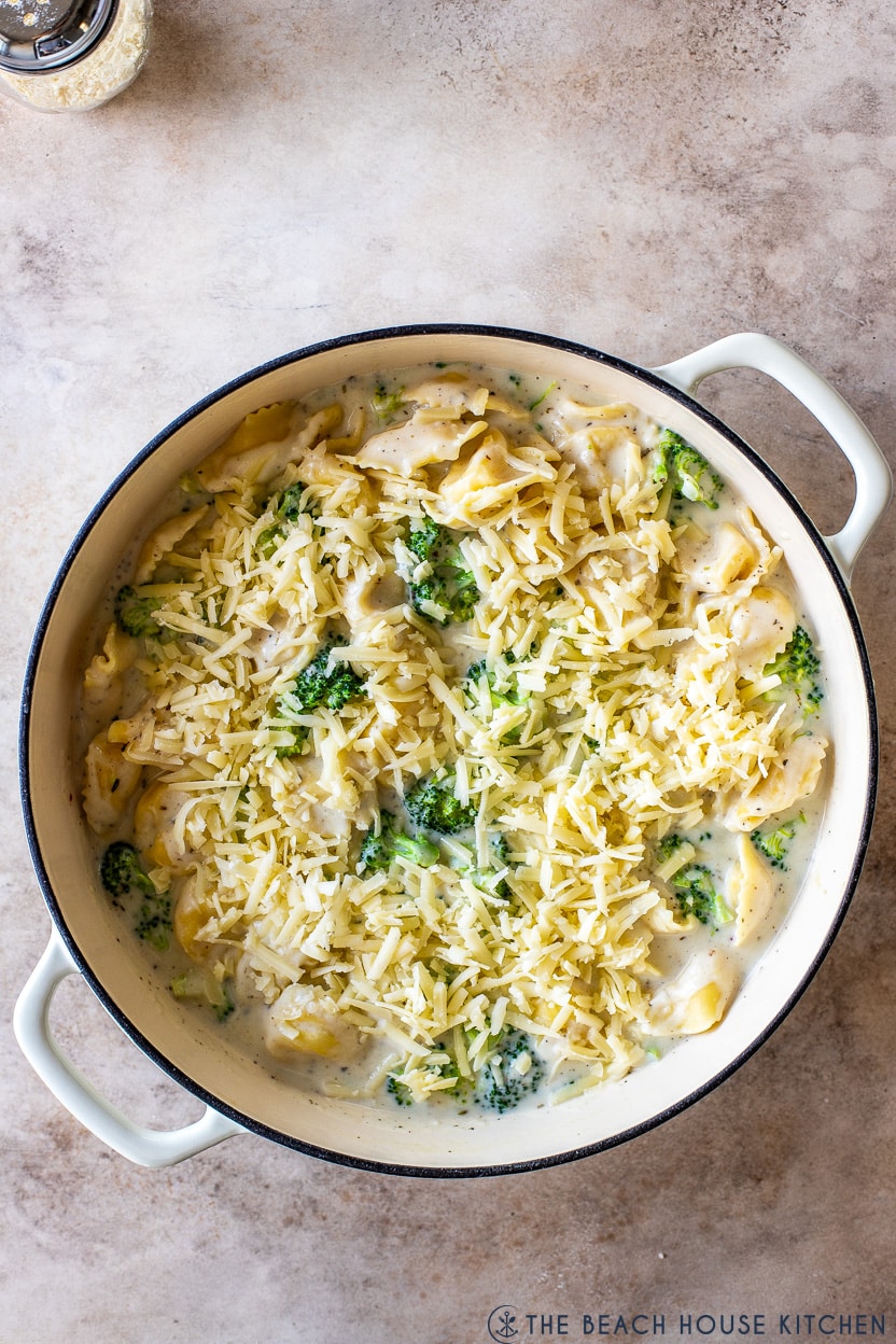 Overhead photo of a pre-baked skillet of creamy cheesy tortellini with broccoli
