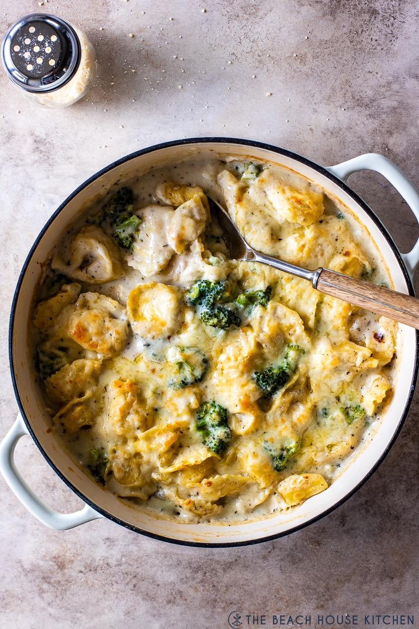 Overhead photo of a skillet of tortellini and broccoli in a creamy cheesy sauce