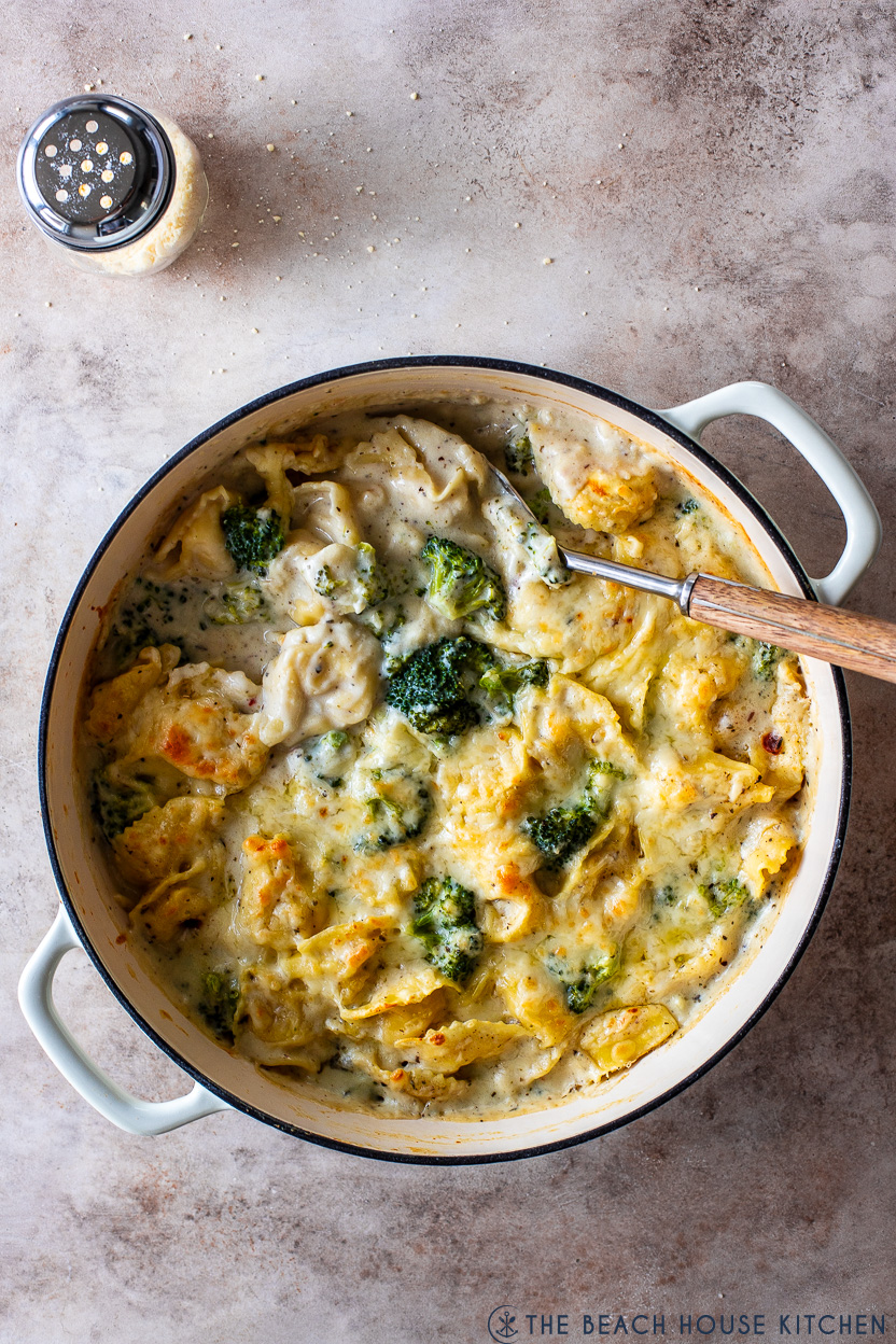 Overhead photo of a skillet of creamy cheesy tortellini with broccoli