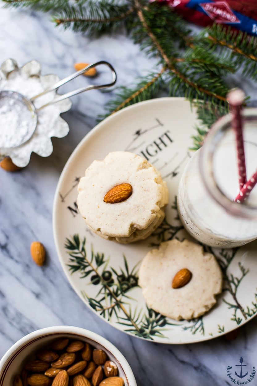 Overhead photo of a stack of almond meltaway cookies on a plate with a bottle of milk
