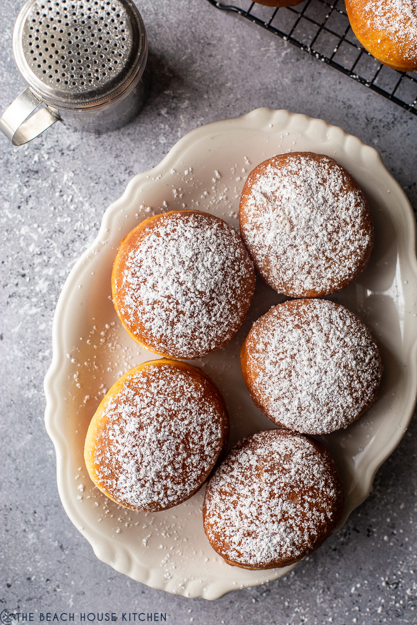 Overhead photo of an oval plate of five Hungarian doughnuts
