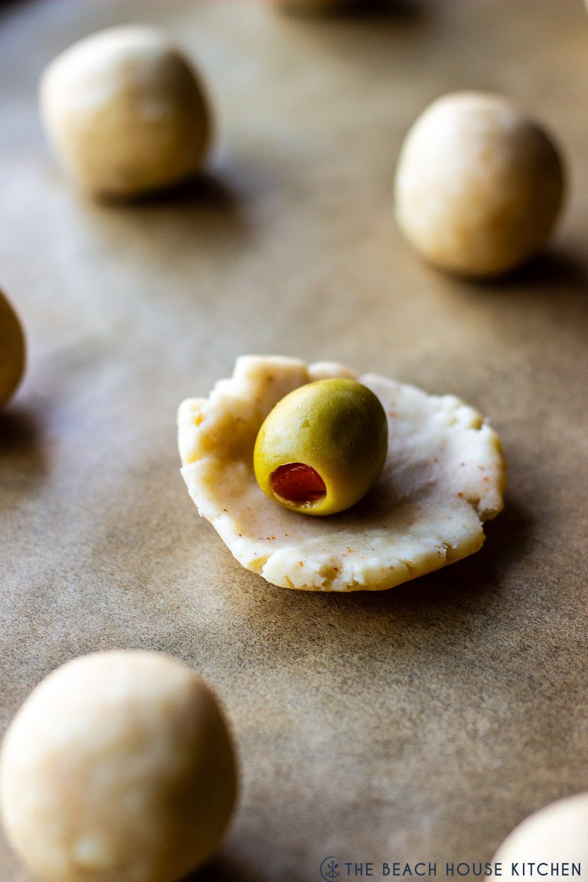Photo of a prewrapped olive with a piece of cheese pastry