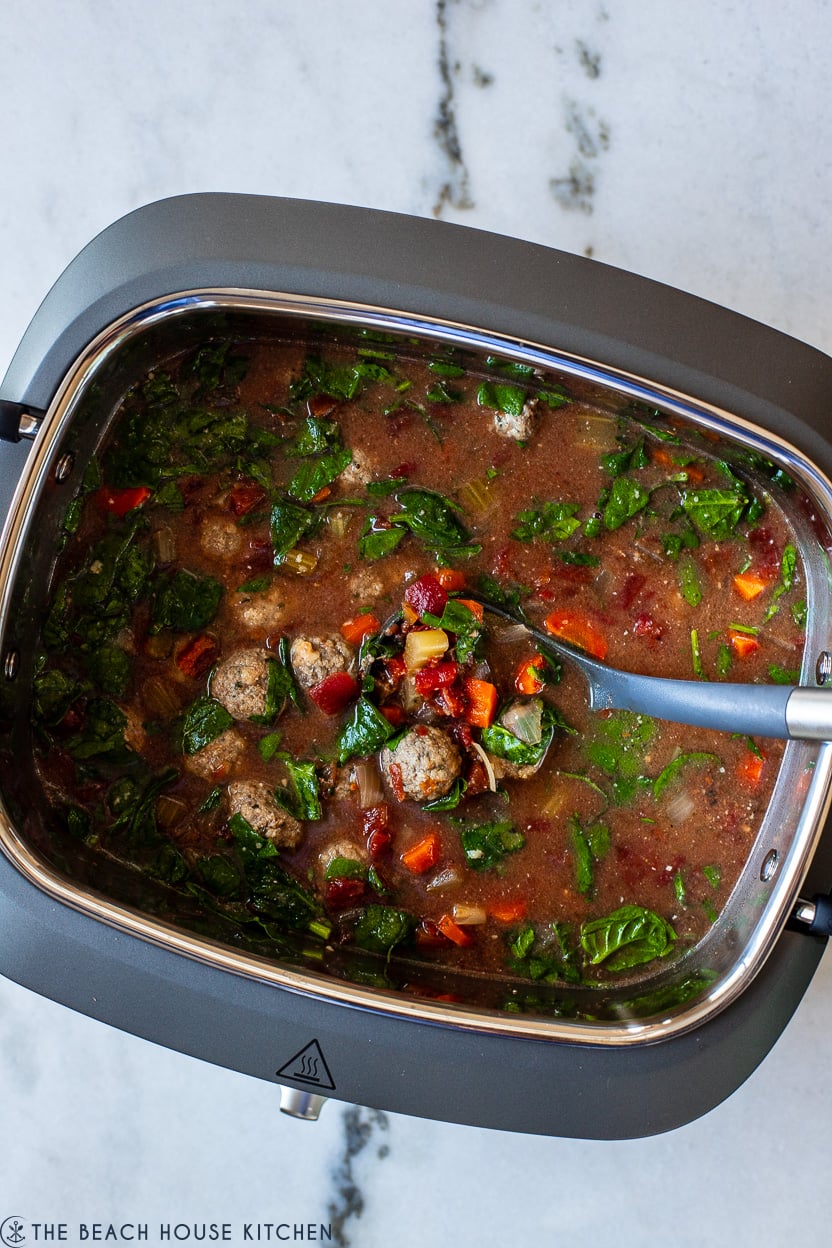 Overhead photo of a slow cooker filled with Italian meatball soup